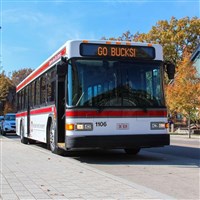 CABS bus driving on roadway with "Go Bucks" on the sign